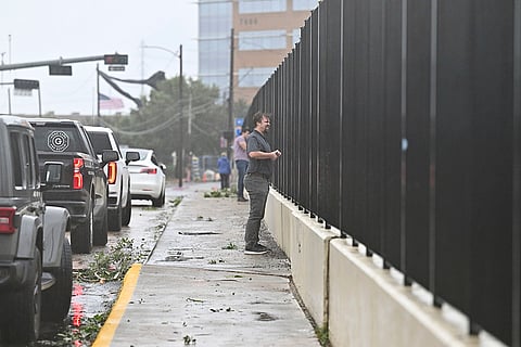 On lookers take photos of high waters